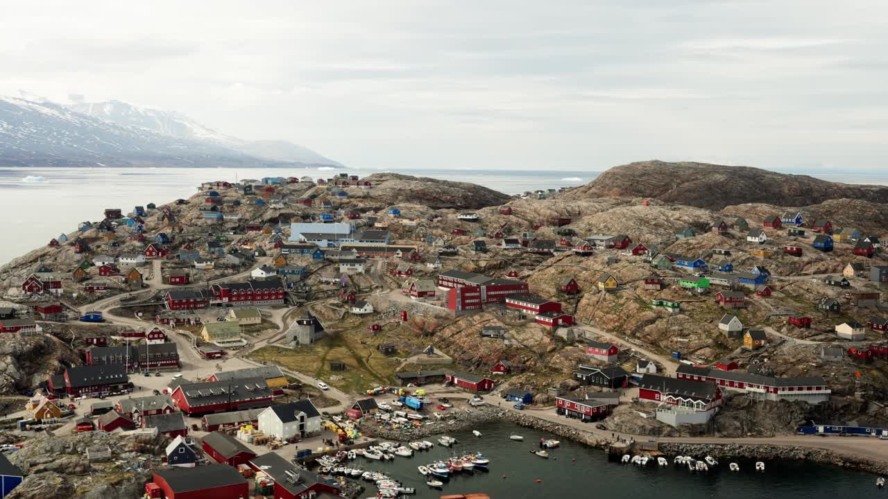 Flying over the city of Uummannaq, shot handheld out of the local helicopter