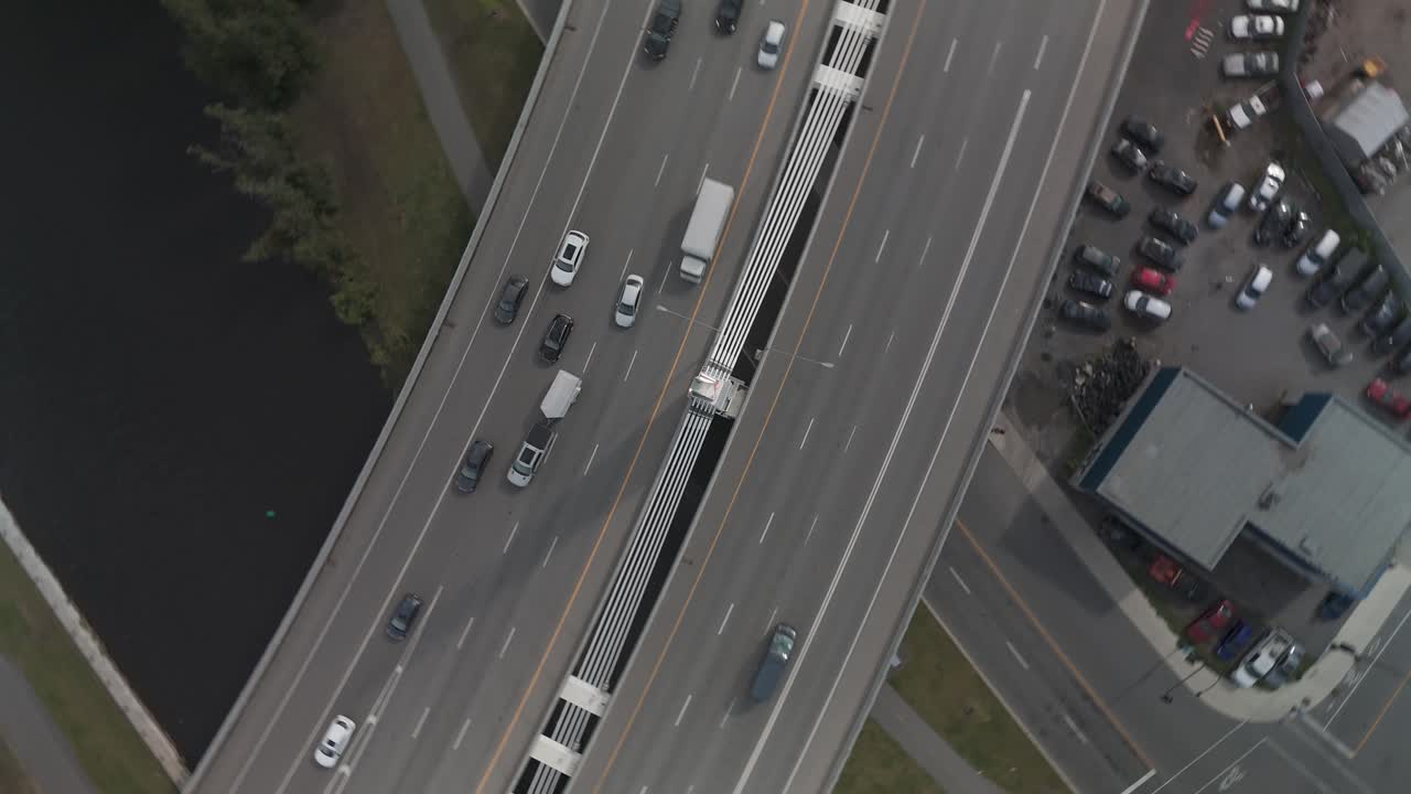 A drone shot of cars and trucks on Turcot interchange. Spinning movement from camera looking down.