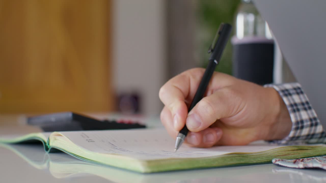 Person writing in a notebook