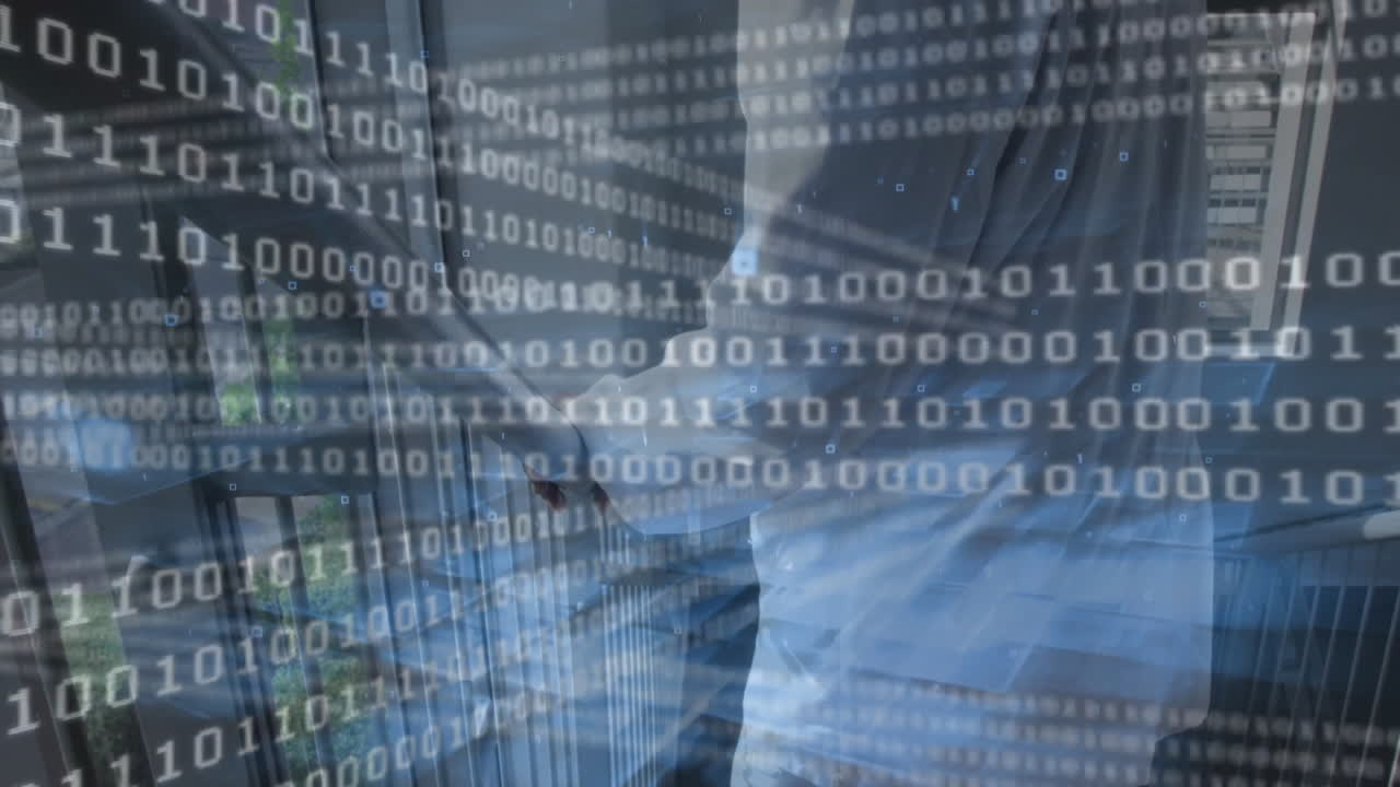 IT professional reviewing smartphone data in corridor, with binary code animating on glass railing