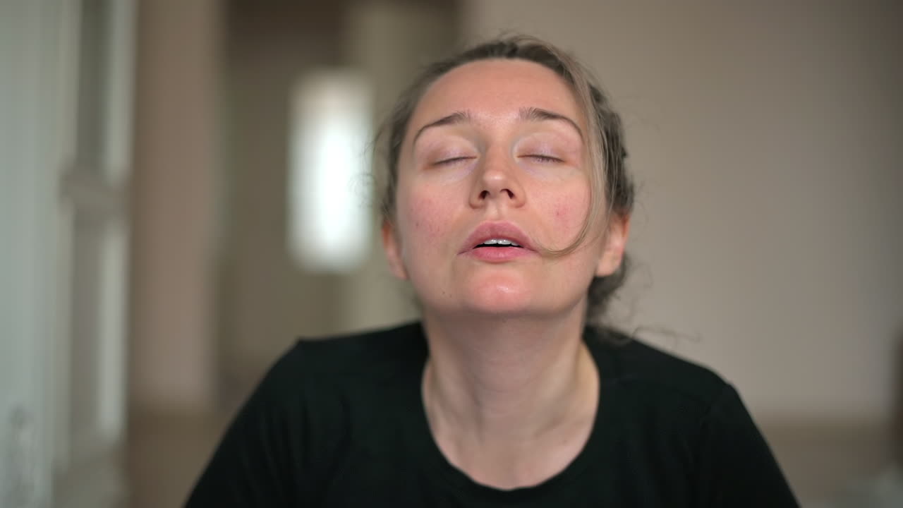 Close up of a woman in sportswear stretching at home