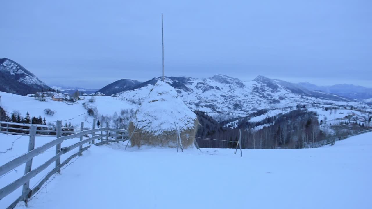 Romanian snowy mountains landscape view, near Bran town, on a moody and cloudy day