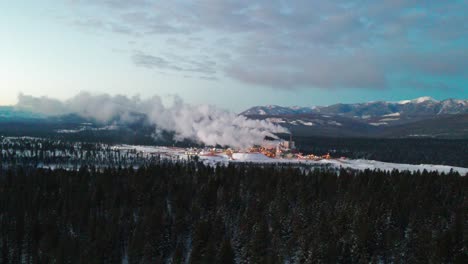 aerial view of pulp mill in cranbrook, british columbia: industrial facility and machinery processing raw materials for paper production in the cold winter weather