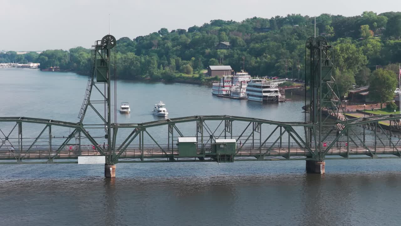 Aerial telephoto close-up panning shot of the lift bridge over the St. Croix River in Stillwater, Minnesota. 4K