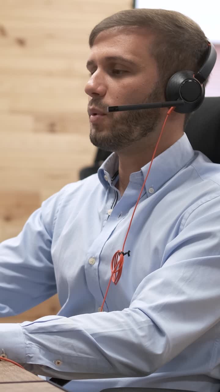 Engaging telemarketer communicating with customers over the phone. Vertical footage