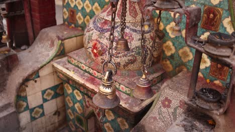 traditional bell ringing at temple in kathmandu, nepal at the base of the himalayas