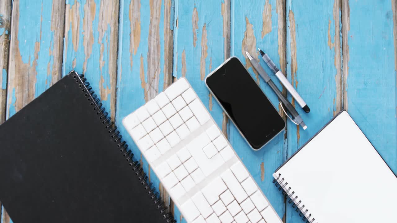 Diary, keyboard, smartphone and pens