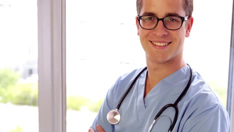 Young-surgeon-smiling-at-camera-with-arms-crossed