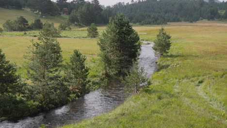 an amazing beautiful landscape view of river streaming in the green fields