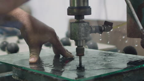 Slow-motion-close-up-of-tradesmen-drilling-hole-in-glass-panel