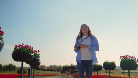 Glückliche-Fotografin,-Die-An-Sonnigen-Tagen-In-Zeitlupe-Im-Blühenden-Park-Läuft.