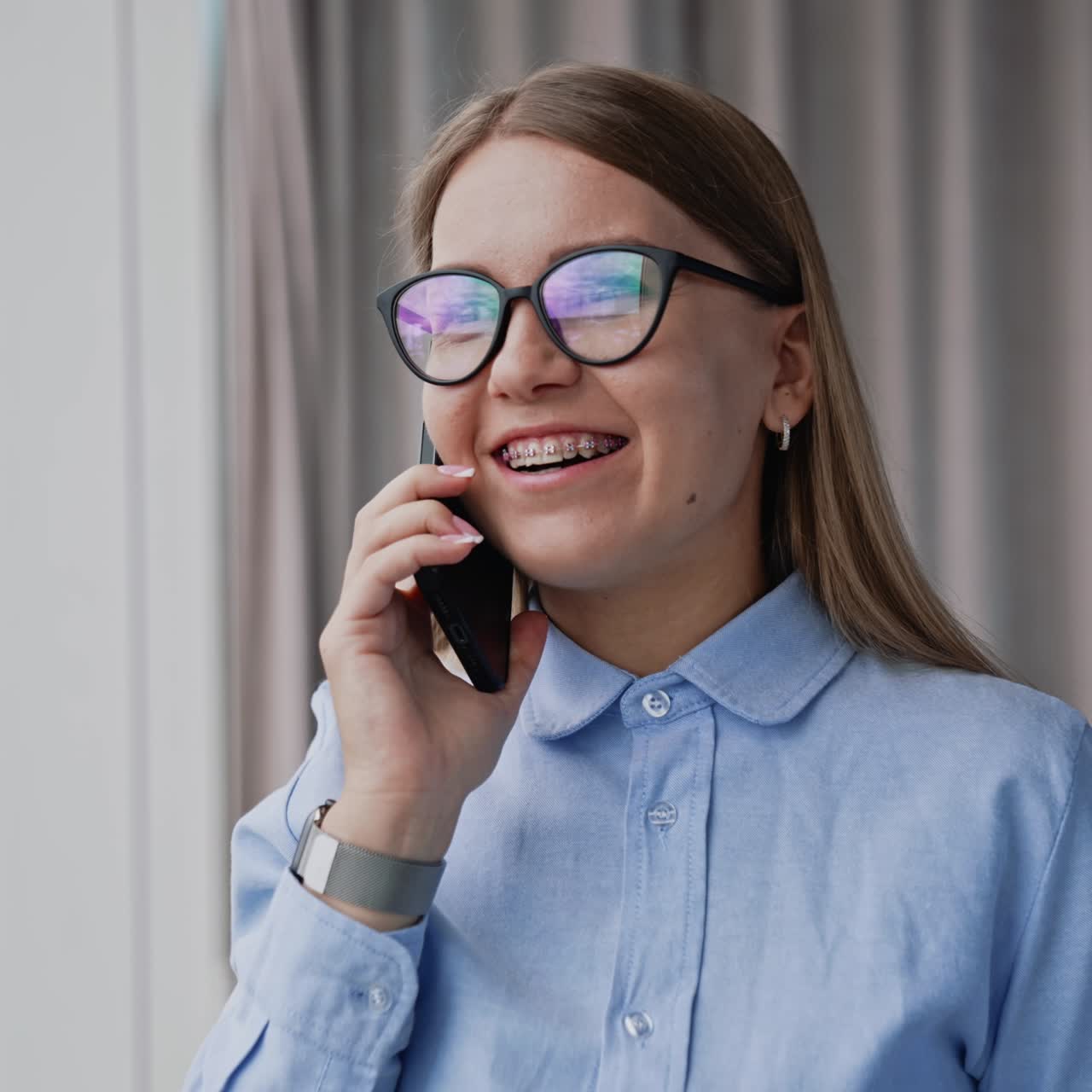 Business phone call in modern office. Successful young lady smartphone talking
