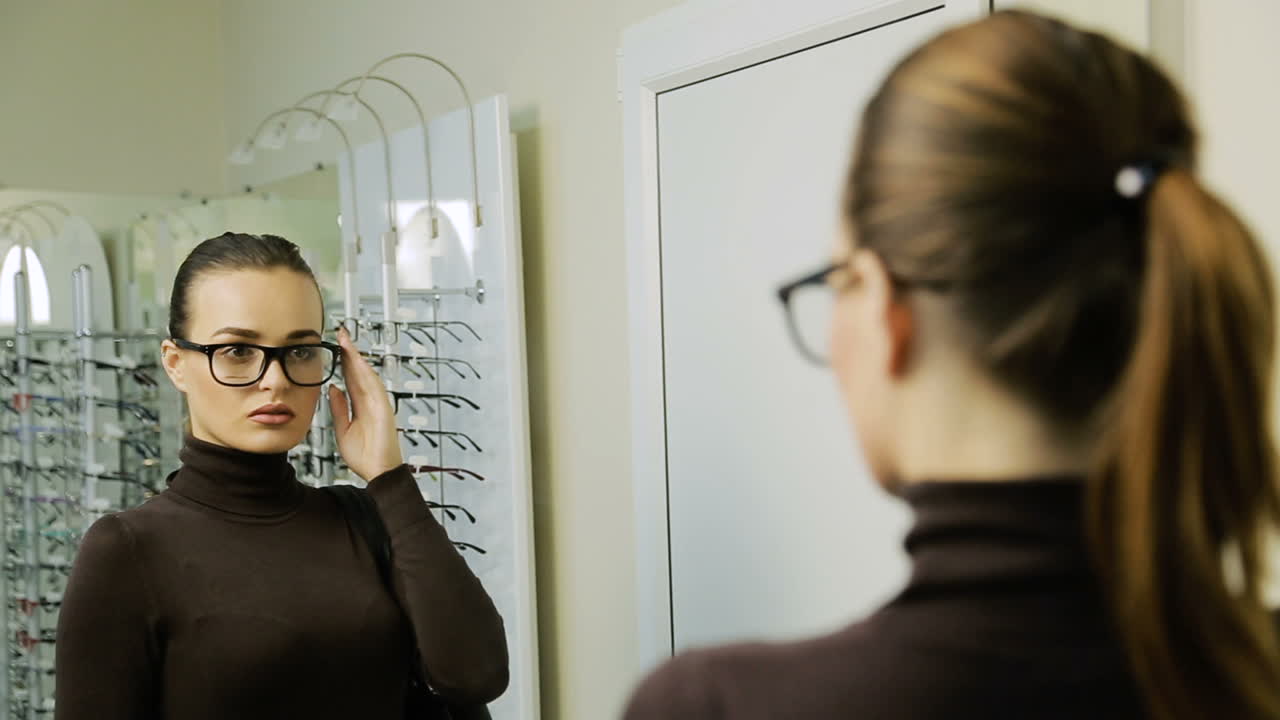 Woman choosing eyeglasses. Woman looking at display and choosing new glasses in optical shop
