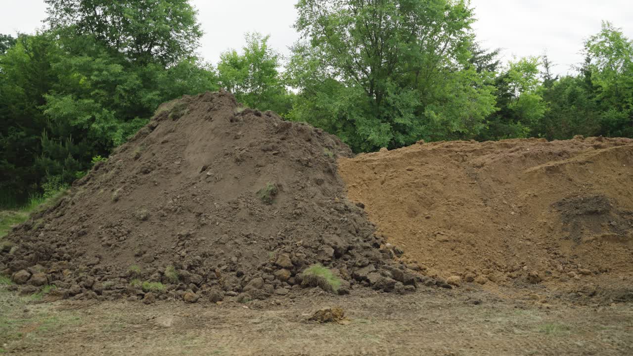 Two dirt piles for backfill and landscaping at pool build site in Wisconsin