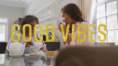 animation of good vibes text over two women talking and having tea at home