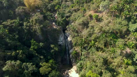 drone ascending on cascada de yelapa flowing from sheer tropical mountains in jalisco, mexico