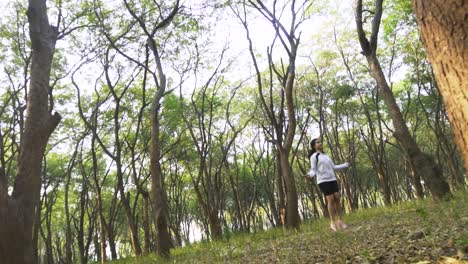 Athletic-Beautiful-Woman-Exercises-with-Jump,-Skipping-Rope-in-the-forest