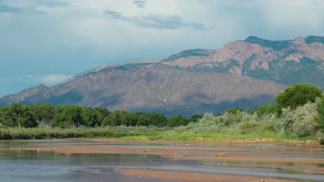 the rio grande river with sandia mountains