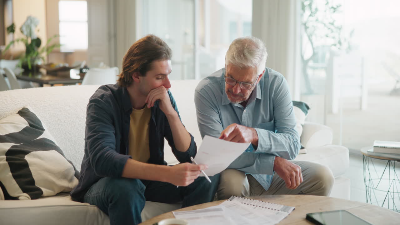Father and son discussing finances at home