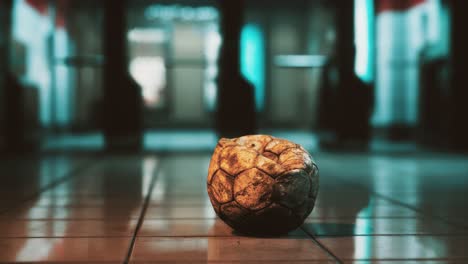 old soccer ball in empty subway