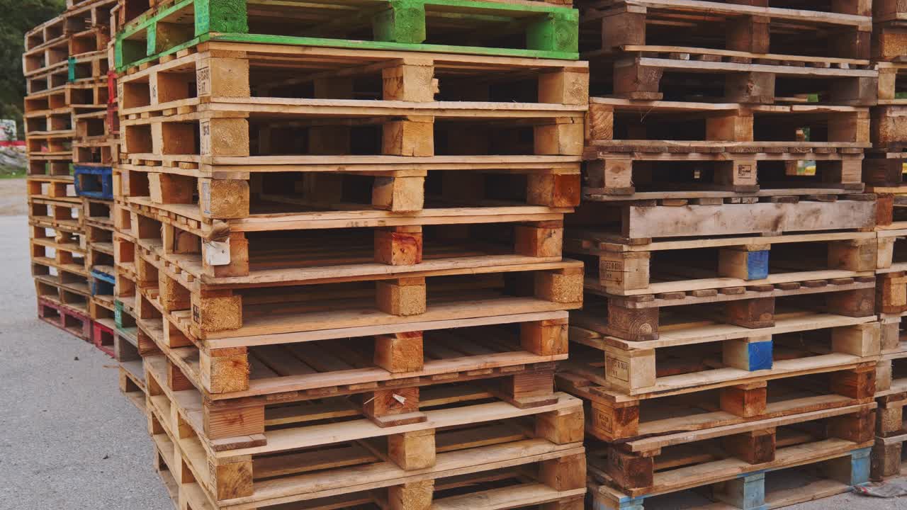 Rows of wooden stacked freight pallets in goods warehouse transport yard
