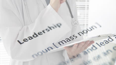 holding clipboard, doctor with leadership definition animation overlaid in hospital