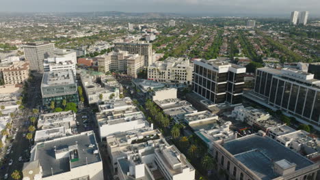 flying over the city of beverly hills, california, looking down at busy streets lined with palm trees