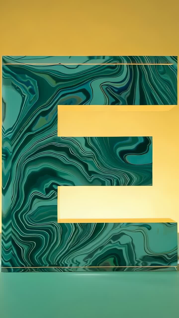Vertical video: Shifting light causing marbled 3D letter E interior cutouts glowing in studio