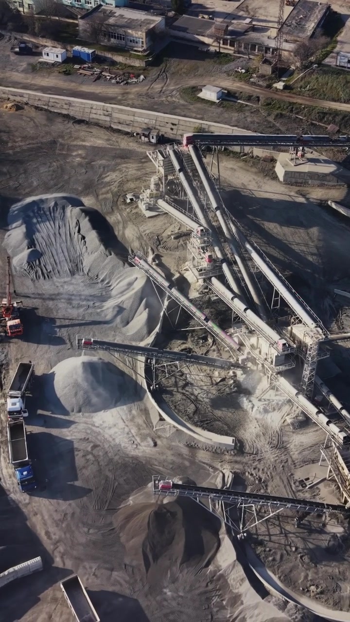 View of a quarry with machinery and storage areas during the day