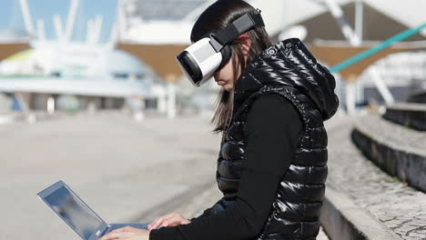 Side-view-of-young-dark-haired-woman-in-warm-black-waistcoat-wearing-virtual-reality-glasses