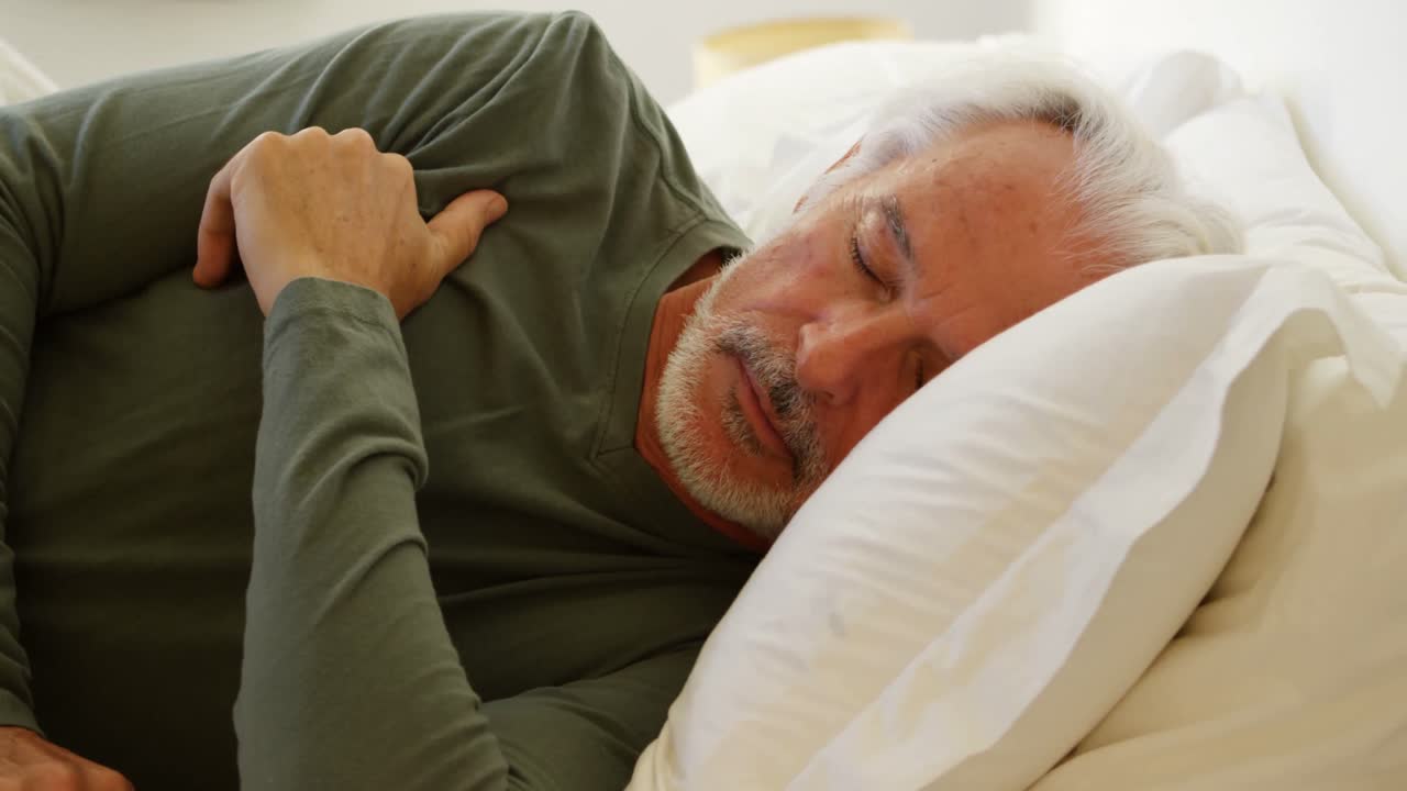 Senior man sleeping on bed in bedroom 4k | Premium Stock Video Footage
