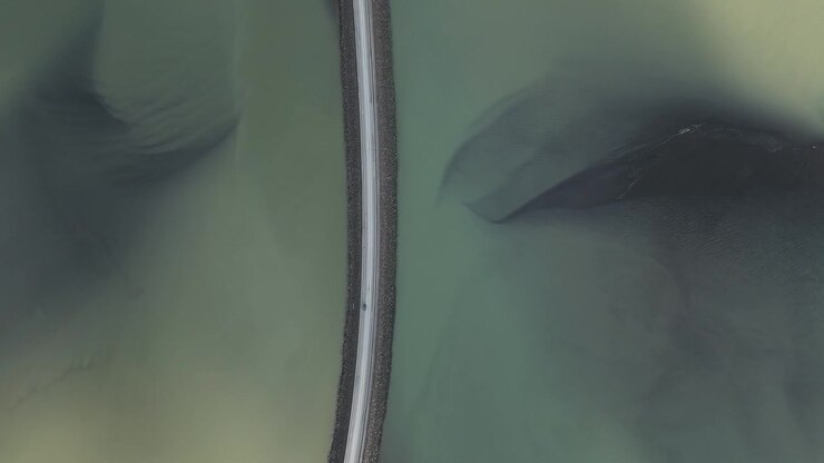 Spanning Concrete Bridge Across Borgarnes Town In Borgarfjordur, Iceland. Aerial Topdown Shot