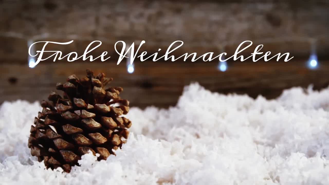 animation des deutschen grußtextes über weihnachts-kiefernkegeldekoration