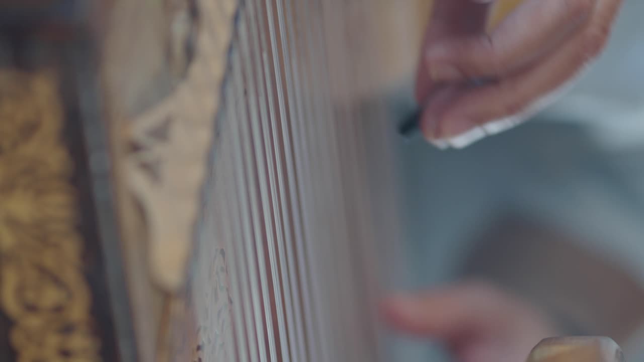 Close-up of a Hand Playing a Harp