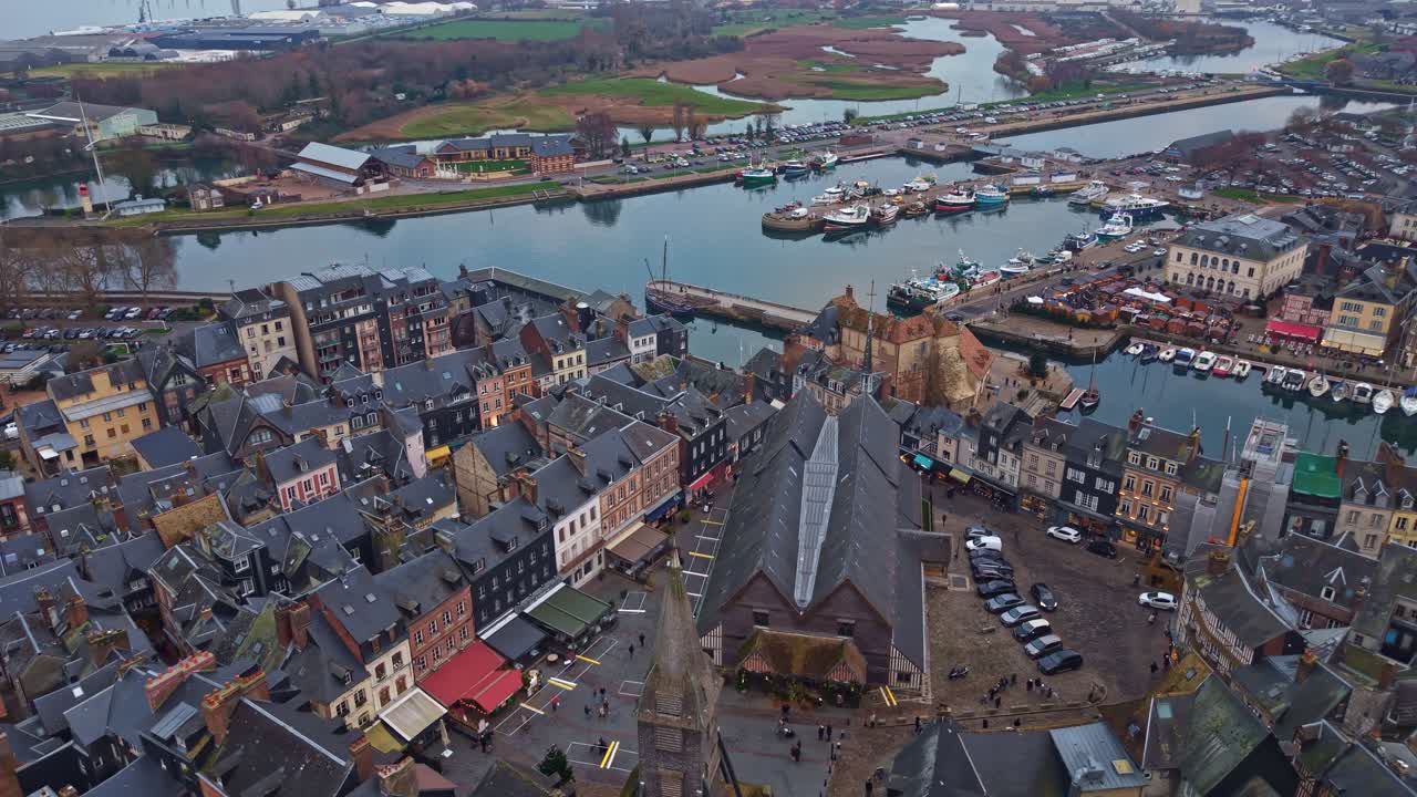 Historyczne miasto, drewniany kościół Świętej Katarzyny i port Vieux Bassin w Honfleur, we Francji. Ujęcie z lotu ptaka z podniesieniem kamery.