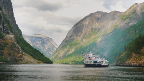 a small cruise ship with tourists begins a trip to the fjord in norway travel and tourism in scandin