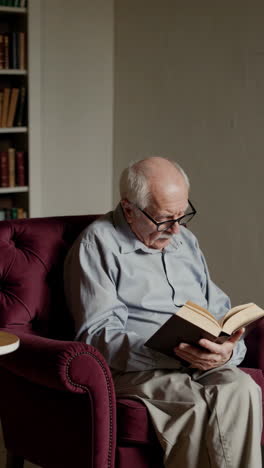senior man reading in armchair