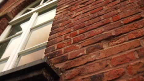 Wall-of-a-brick-house-in-Germany-with-large-white-windows