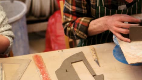 potters working in pottery shop