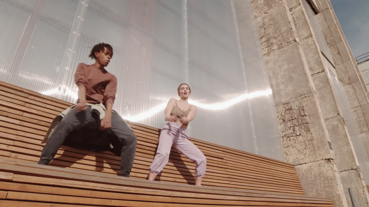 Dancers on Wooden Bench Outdoors
