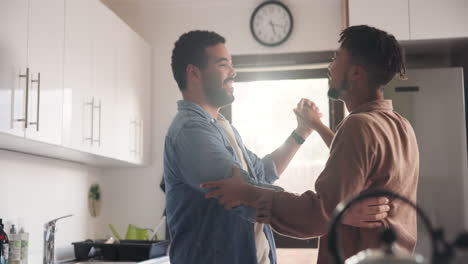 happy couple dancing in kitchen