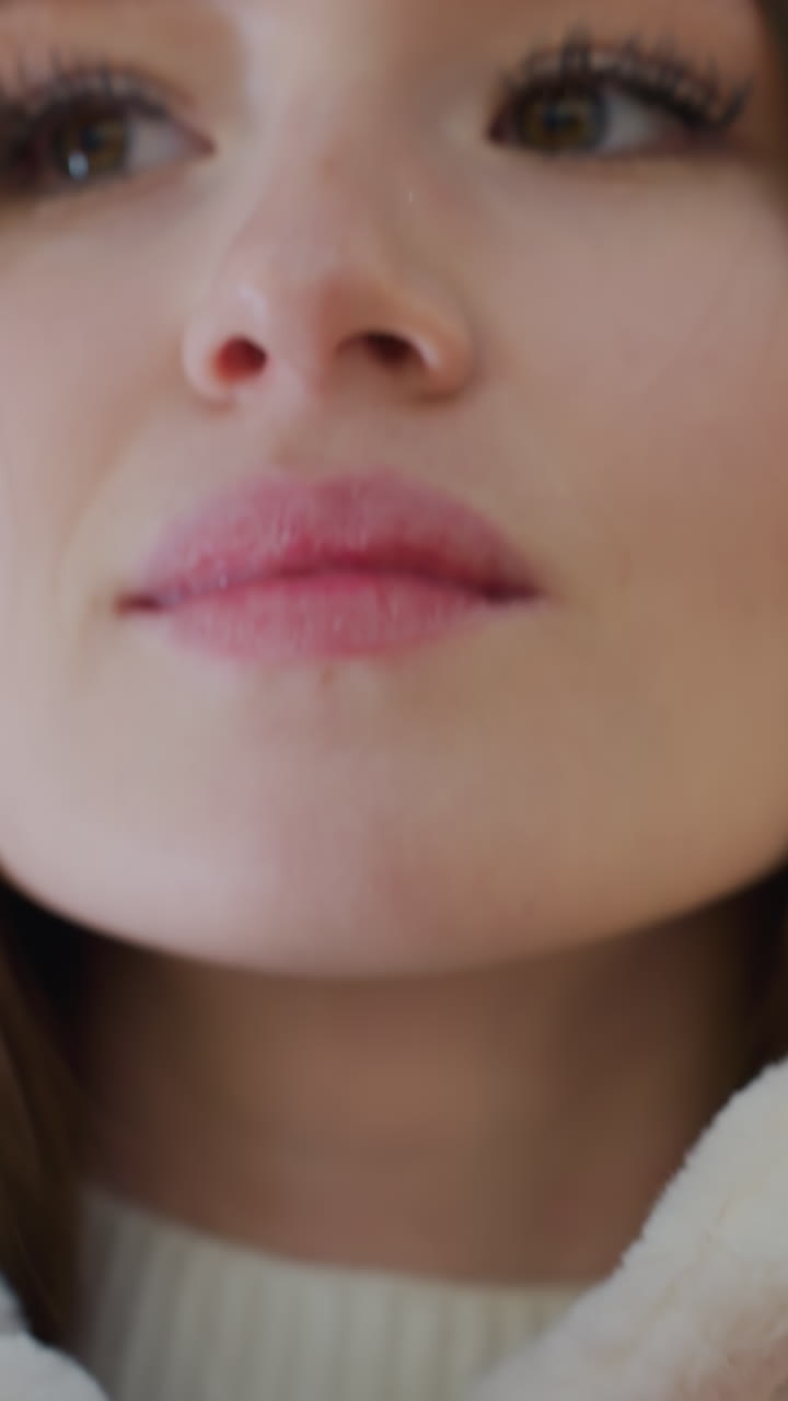 Close-up of woman hands zipping up a soft, fluffy winter jacket with a blurred background featuring a decorated Christmas tree, cozy outerwear fashion for cold weather in a stylish seasonal setting