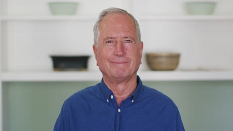 portrait of happy senior caucasian man at home smiling to camera