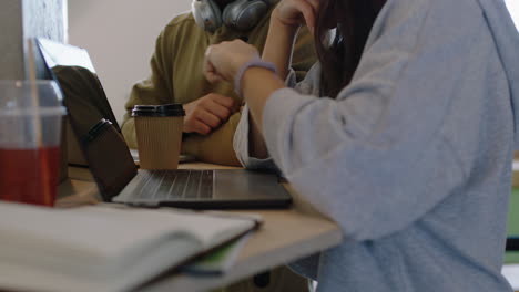 young diverse business people brainstorming team leader woman sharing ideas working together showing colleague typing using laptop computer in trendy workplace