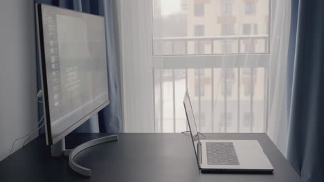 home office workspace with computer and laptop