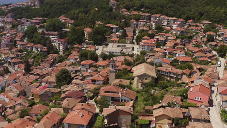 drone flies towards american collage arcus in medieval city veliko tarnovo