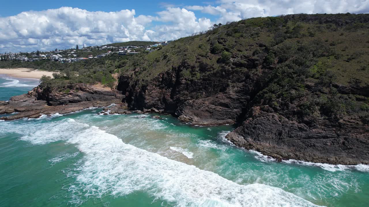 Aerial View Of Waves Crashing Against The Rocky Cliffs And Coastline