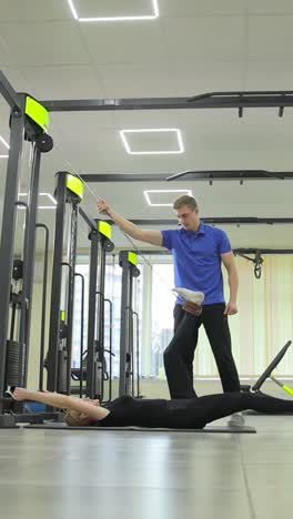 physical therapist assisting patient with leg exercise