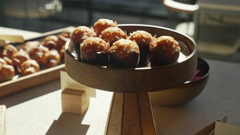 freshly baked muffins presented on a wooden plate during a delightful and sunny morning brunch, creating a mouthwatering and visually appealing breakfast experience