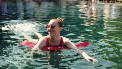 woman swimming with float